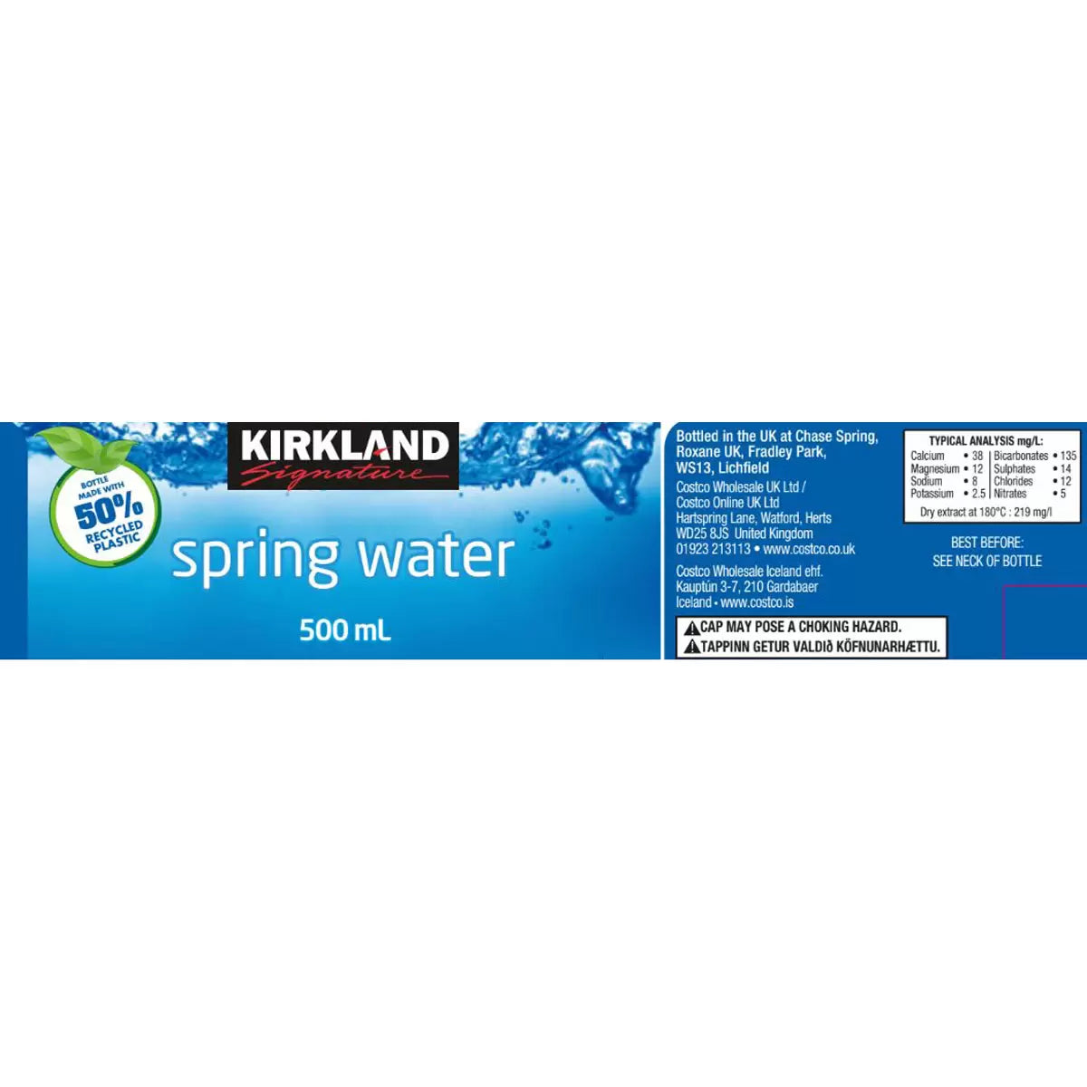 Label of Kirkland Signature Spring Water 500 mL bottle, featuring branding, mineral analysis, and a note that the bottle is made with 50% recycled plastic.