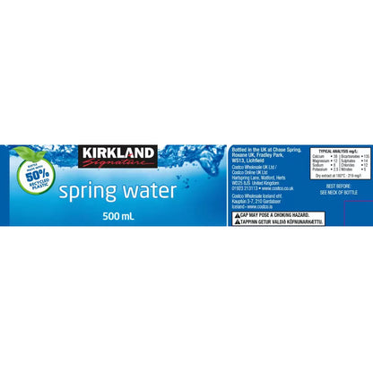Label of Kirkland Signature Spring Water 500 mL bottle, featuring branding, mineral analysis, and a note that the bottle is made with 50% recycled plastic.